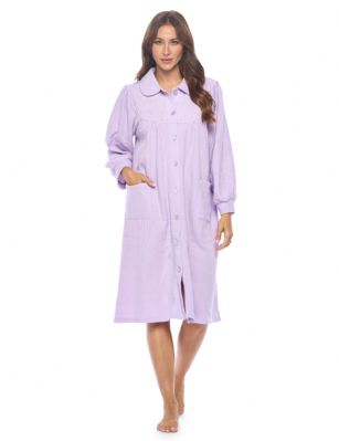 Casual Nights Women's Button Front Jacquard Terry Fleece Lounger Robe with Pockets - Lilac Purple - Introducing our Soft Fleece Lounger Robe: the ultimate solution for staying comfortably warm while embracing your preferred lighter nightwear. If you're someone who runs hot but loves the snugness of a warm layer, this lounger house dress is tailored just for you. Designed to complement thinner nightgowns, it's the perfect companion for bedtime reading or TV watching. Tired of grappling with lengthy robes? Embrace the ease of our innovative bed robe, effortlessly removable, draping gracefully as you embrace peaceful slumber.Experience the coziness firsthand. Imagine the soothing embrace of this house coat during post-surgery recovery. Similar to a beloved lounger, this fleece wonder boasts a flattering collar, button-up front, and deep side patch pockets  a handy touch for stowing tissues, candy, or your cell phone. No need to compromise style for comfort  this bed jacket effortlessly combines both.And that's not all. We believe in the power of heartfelt gifting. Our lounger robe found a special place in the heart of a 99-year-old friend who perpetually battled the cold. This thoughtful gesture not only brought warmth but also beamed with love. You'll cherish its impact, just as she did.Made from easy-care polyester, this imported knee length bed longer measures approximately 42L and is machine washable, making maintenance a breeze. Whether you're winding down after a long day or seeking solace during recovery, our Soft Fleece Bed Lounger robe is your ticket to warm, comfy, and cozy nights.
